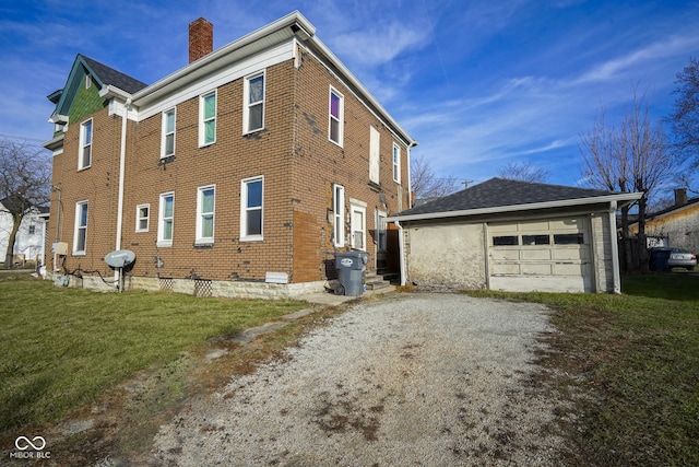 view of property exterior with a garage, an outdoor structure, and a lawn