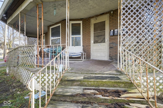 view of exterior entry featuring a porch