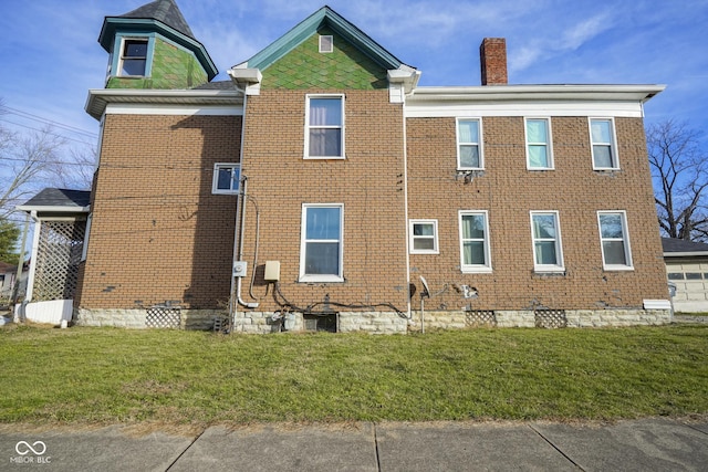 view of side of home with a yard