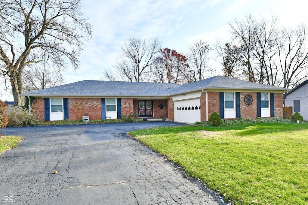 ranch-style house with a front lawn and a garage