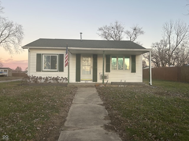 view of front facade with a yard and covered porch