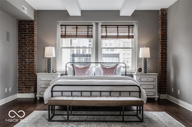 bedroom with beam ceiling and dark wood-type flooring