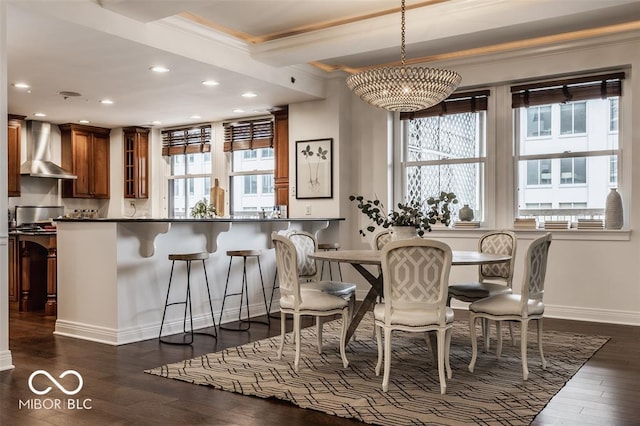 dining room featuring a chandelier, dark hardwood / wood-style floors, and ornamental molding