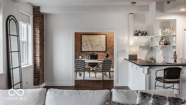 bar featuring white cabinetry, dark hardwood / wood-style flooring, and sink