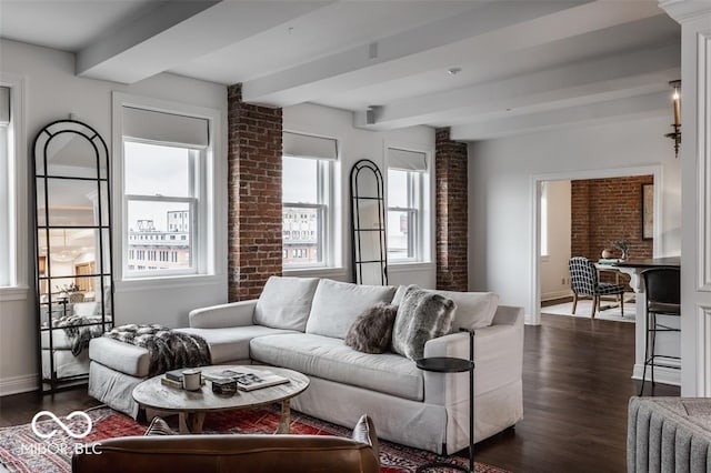 living room featuring beam ceiling, a wealth of natural light, and dark wood-type flooring