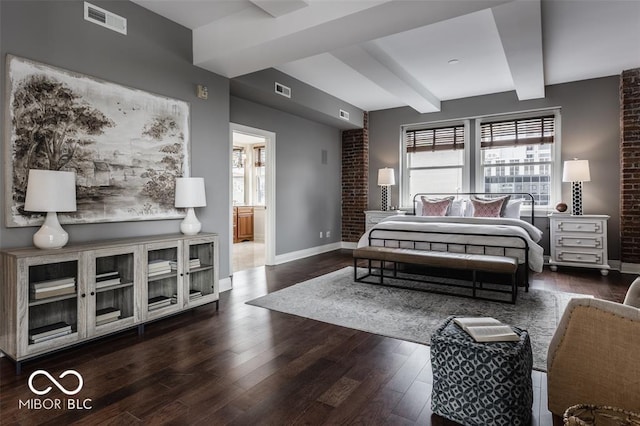 bedroom with dark hardwood / wood-style floors, beam ceiling, and ensuite bathroom