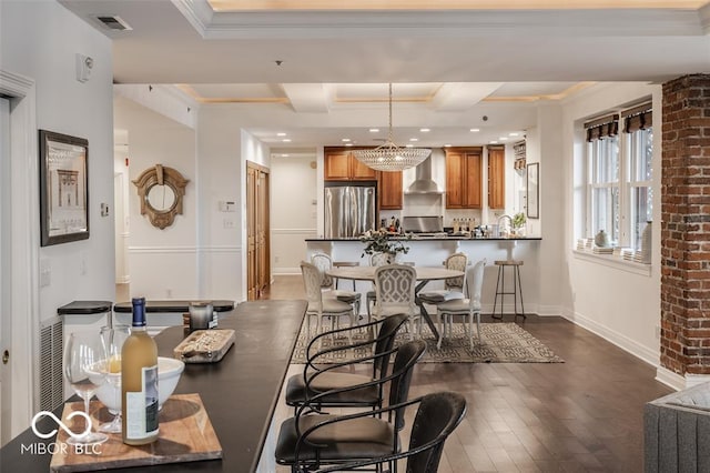 dining room with dark hardwood / wood-style floors, beam ceiling, ornamental molding, and a chandelier