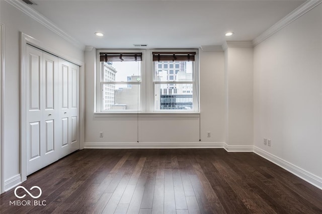 empty room with dark hardwood / wood-style floors and ornamental molding