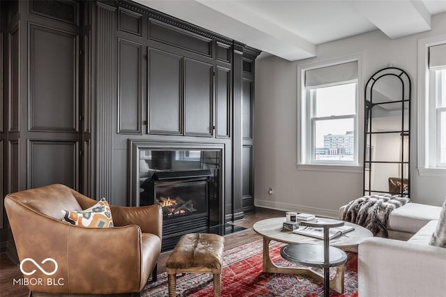 living room featuring a wealth of natural light and dark hardwood / wood-style floors