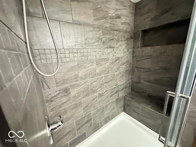 bathroom with a tile shower