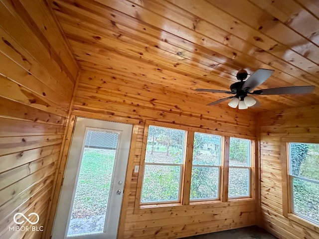 unfurnished sunroom featuring ceiling fan