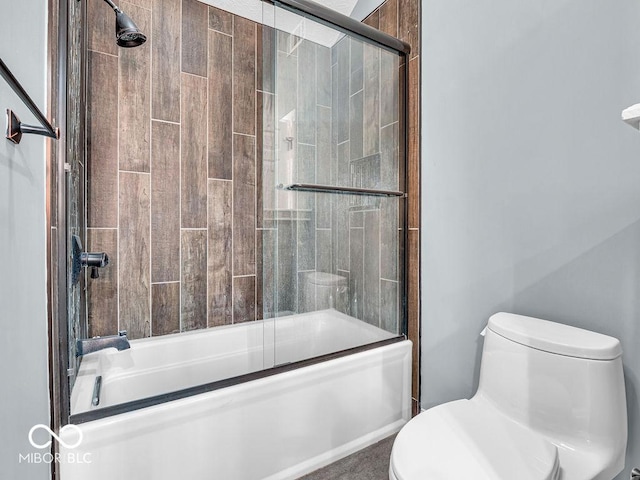 bathroom with shower / bath combination with glass door and toilet