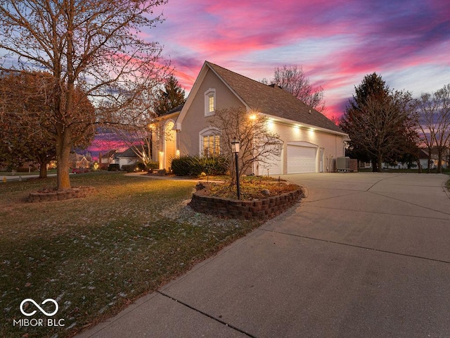 view of front of property featuring central AC unit and a lawn