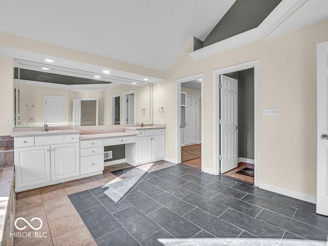 bathroom featuring ornamental molding, vanity, tile patterned floors, and lofted ceiling