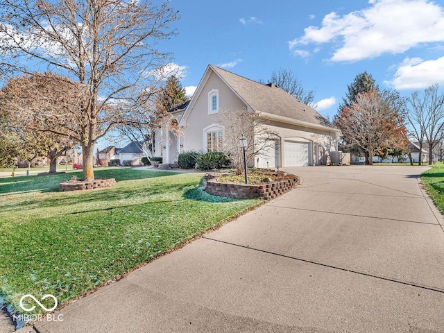 view of home's exterior featuring a garage and a lawn