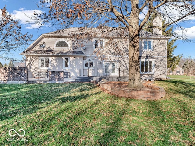 rear view of property featuring a yard