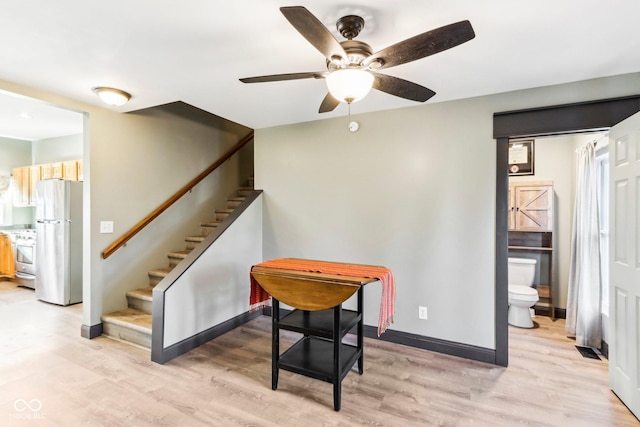 interior space with wood-type flooring and ceiling fan