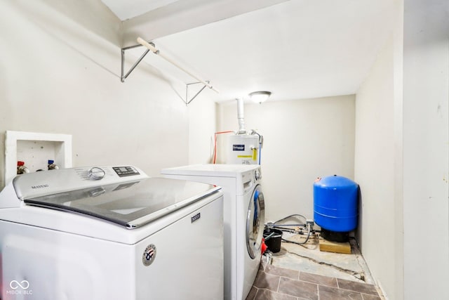 washroom with washer and clothes dryer and water heater