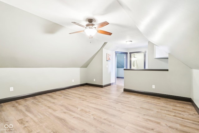 bonus room featuring vaulted ceiling and light wood-type flooring