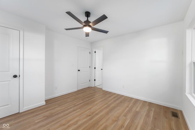 spare room featuring light hardwood / wood-style flooring and ceiling fan