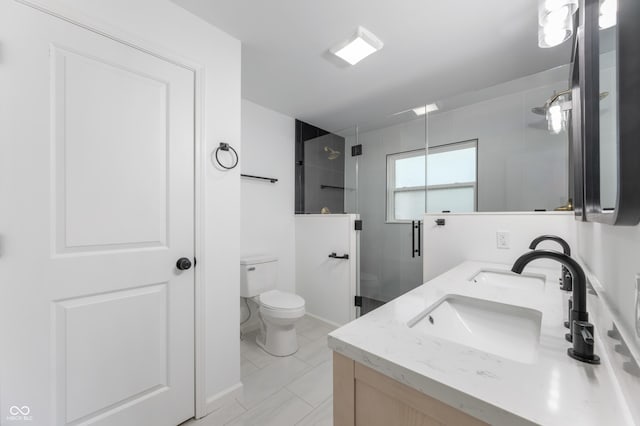 bathroom featuring tile patterned flooring, vanity, toilet, and a shower with door