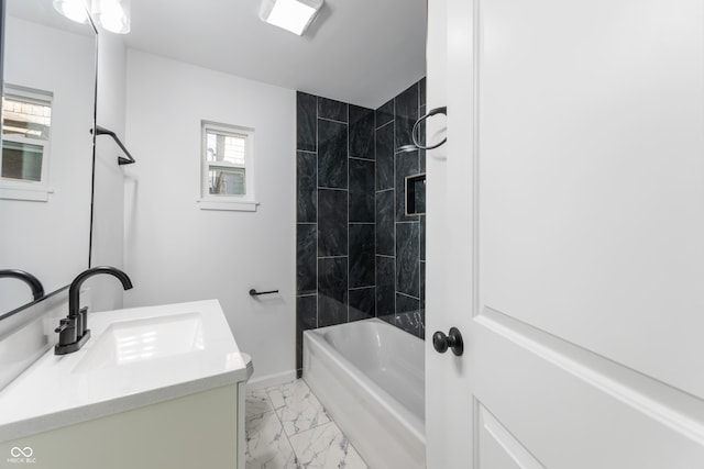 bathroom with vanity and tiled shower / bath combo