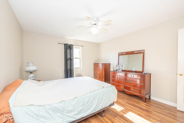 bedroom with ceiling fan and hardwood / wood-style flooring