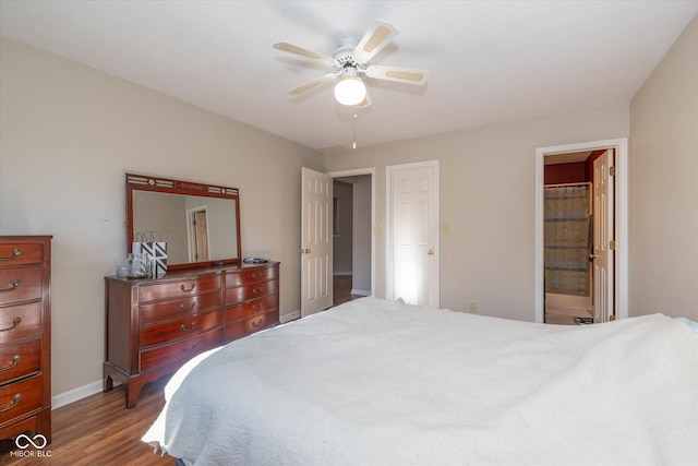 bedroom featuring ceiling fan, connected bathroom, and dark hardwood / wood-style floors