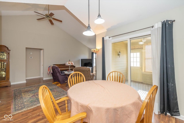 dining room featuring ceiling fan, wood-type flooring, and high vaulted ceiling