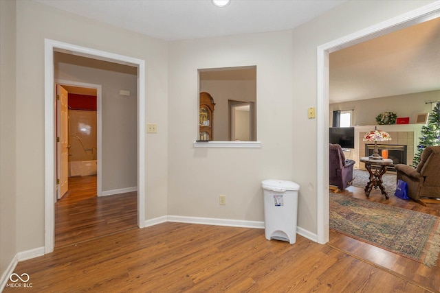 hall with hardwood / wood-style floors