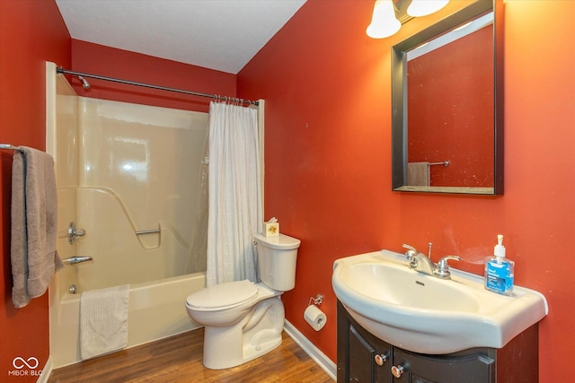 full bathroom with toilet, vanity, shower / bathtub combination with curtain, hardwood / wood-style floors, and a textured ceiling