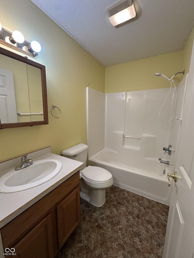 full bathroom with vanity, toilet, a textured ceiling, and shower / washtub combination