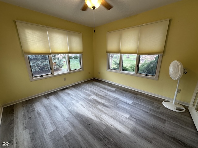 empty room with wood-type flooring and ceiling fan