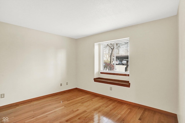 spare room featuring wood-type flooring