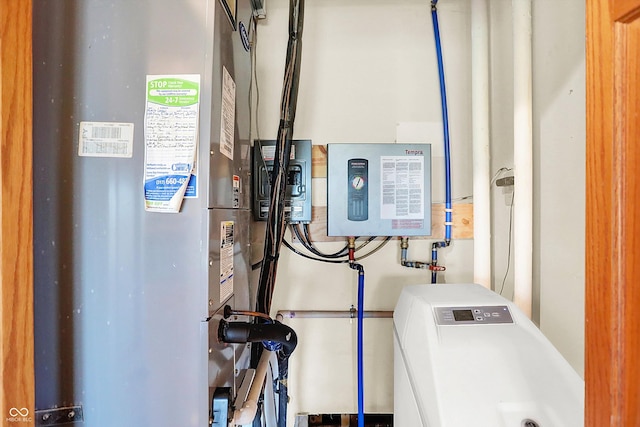 utility room featuring heating unit