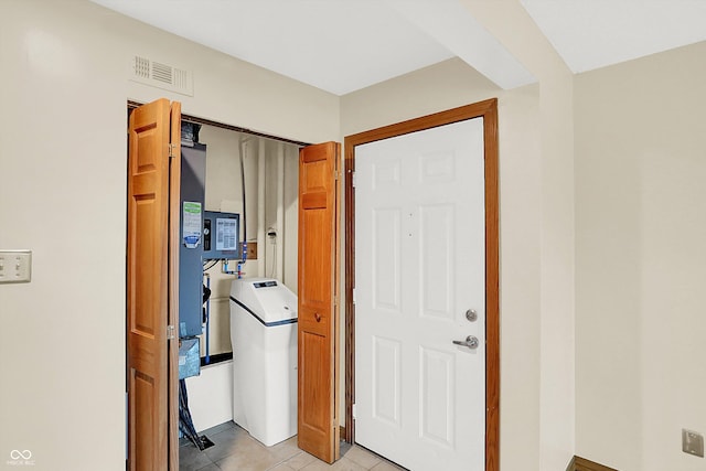 hall featuring light tile patterned flooring