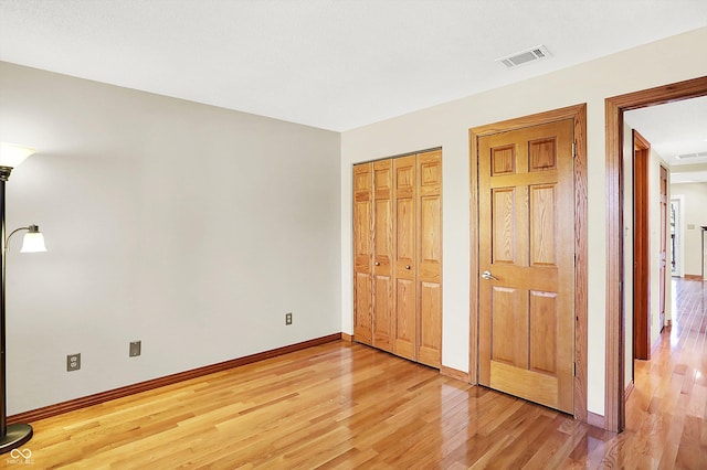 unfurnished bedroom with hardwood / wood-style floors