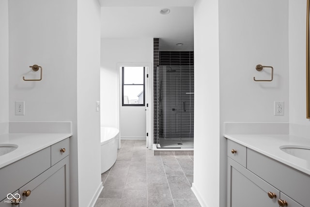 bathroom with tile patterned flooring, vanity, and plus walk in shower