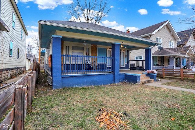 view of front facade with covered porch and a front yard