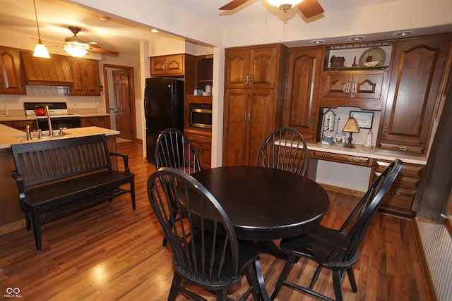 dining area featuring dark hardwood / wood-style flooring and sink