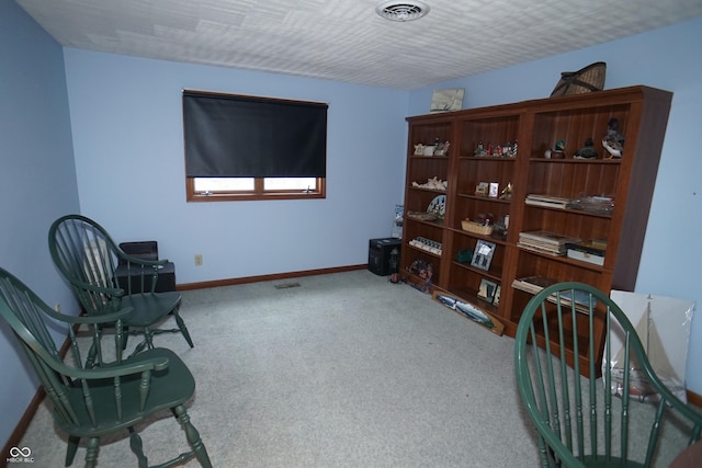 sitting room featuring carpet flooring