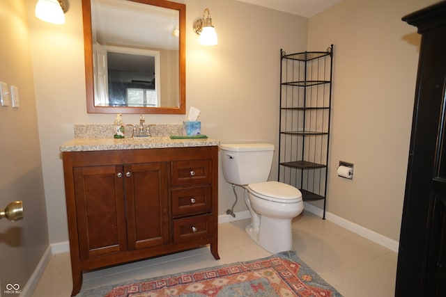 bathroom with tile patterned floors, vanity, and toilet