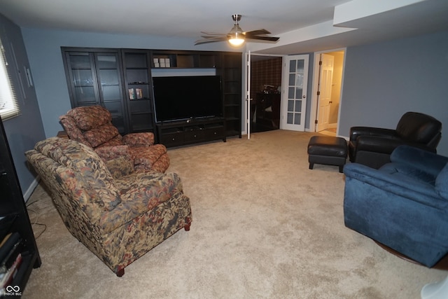 carpeted living room featuring ceiling fan and french doors