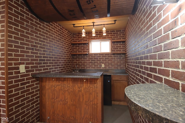 kitchen with brick wall and kitchen peninsula