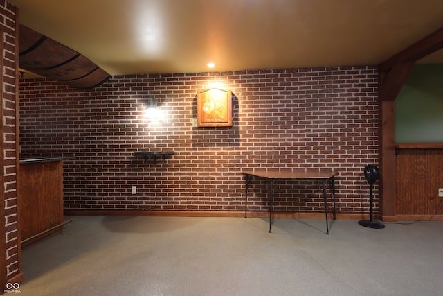 interior space featuring brick wall