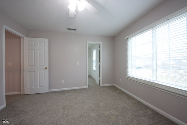 unfurnished bedroom with ceiling fan and carpet flooring