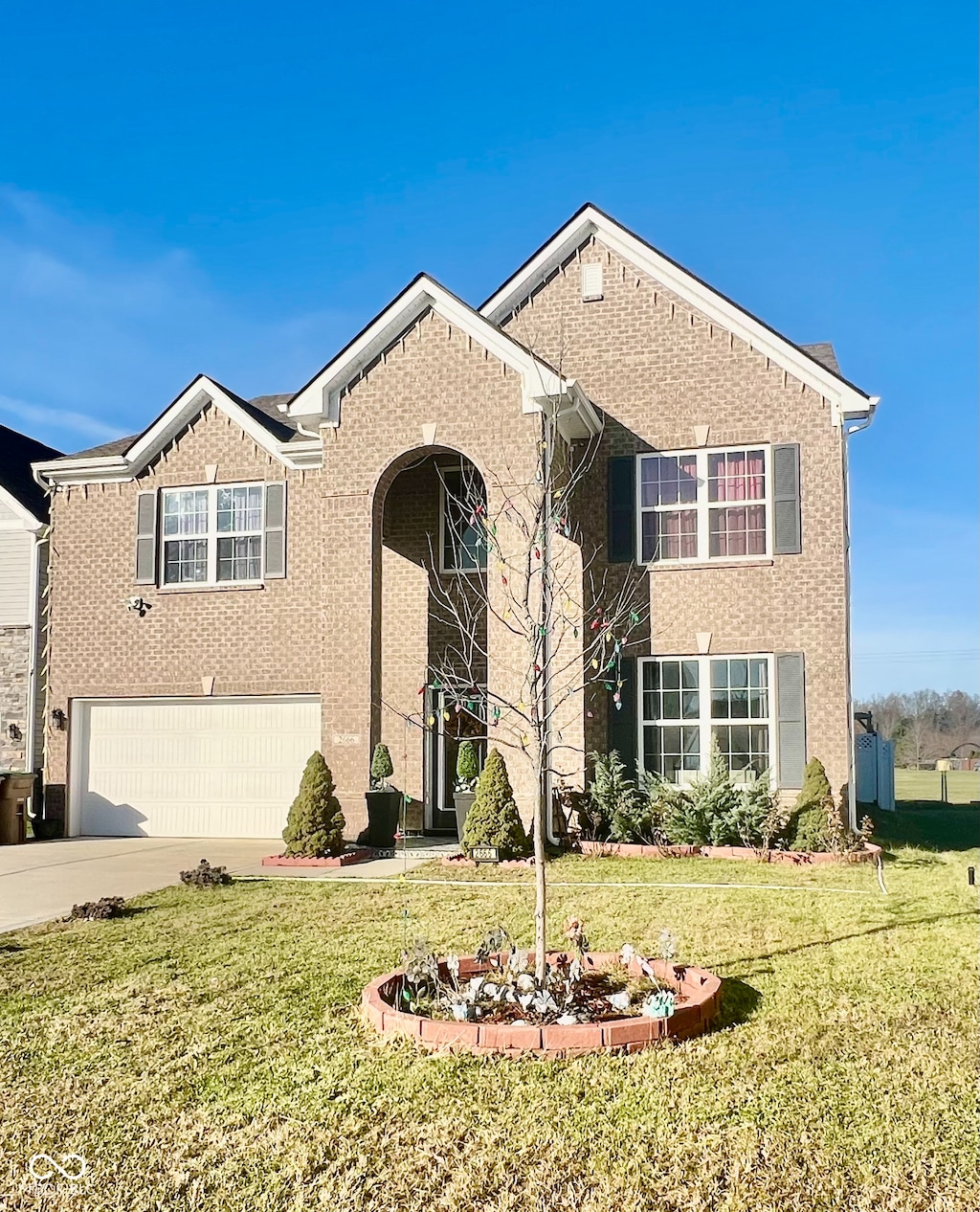 view of front of property with a garage and a front yard