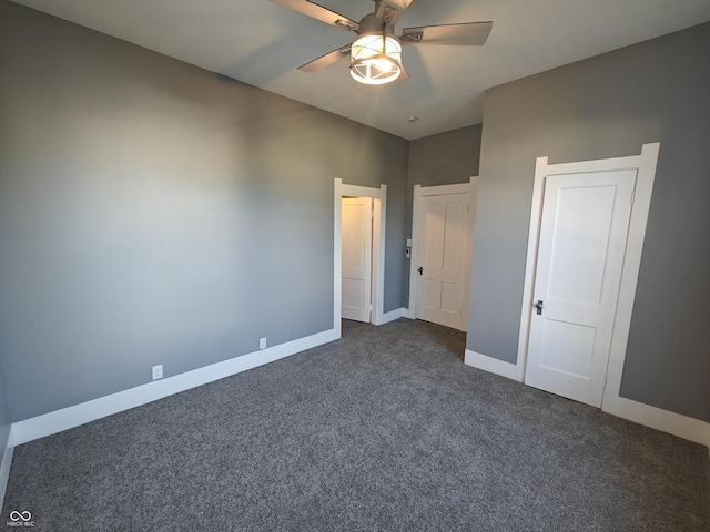 unfurnished bedroom featuring ceiling fan and dark carpet