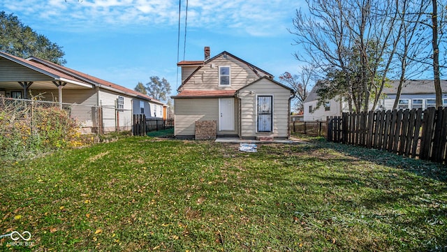 rear view of property with a lawn