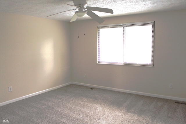 spare room featuring ceiling fan, carpet floors, and a textured ceiling